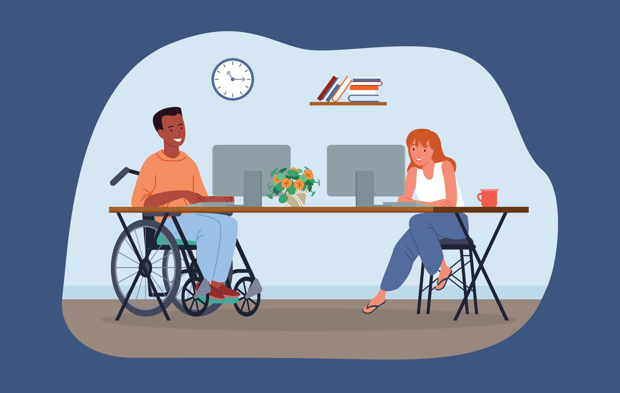 Two coworkers sitting at a shared desk. One of them is in a wheelchair.