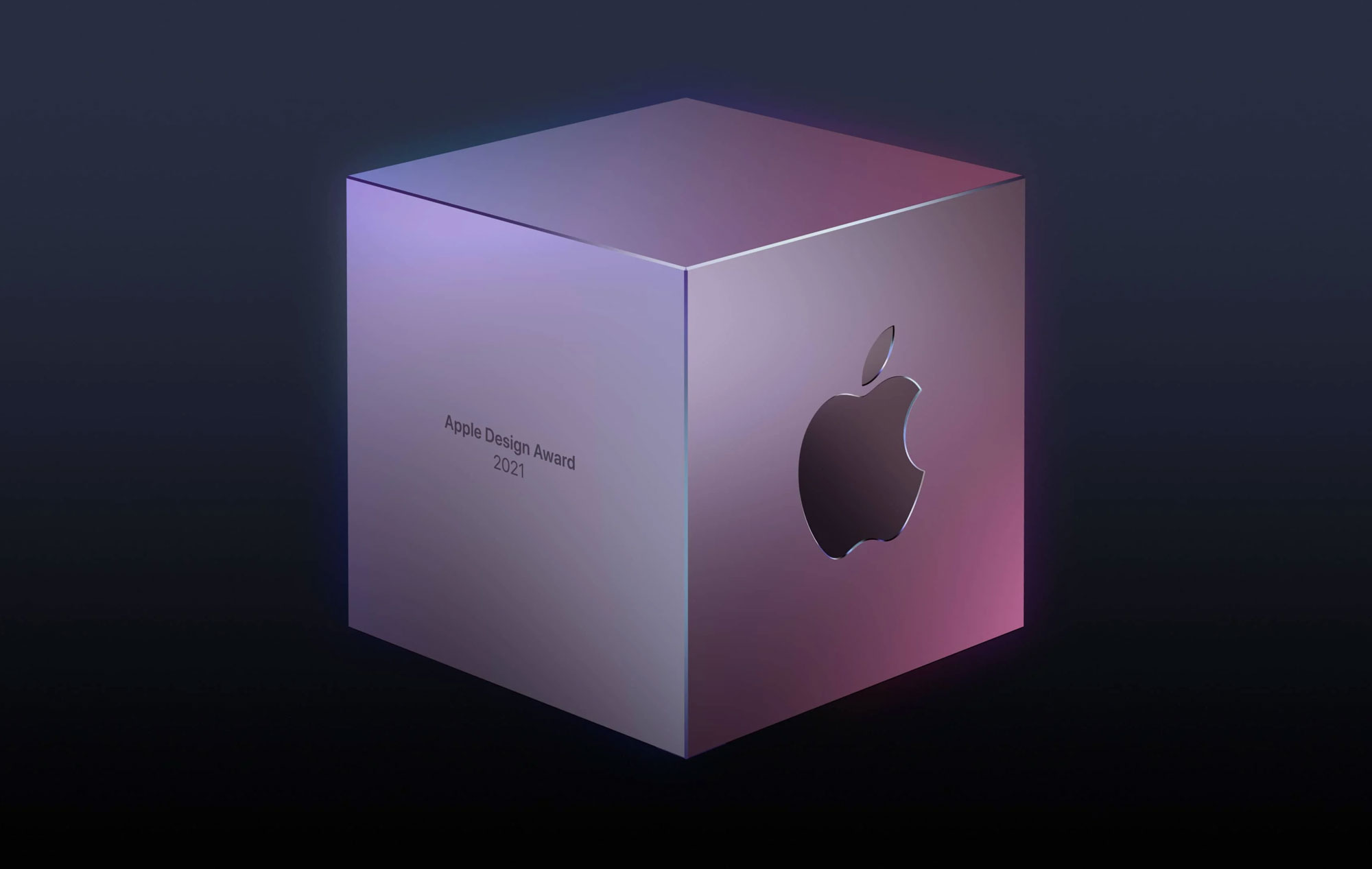 Silver cube with a purple glow. On the right side of the cube is the Apple logo and on the left side is text that says, Apple Design Award 2021